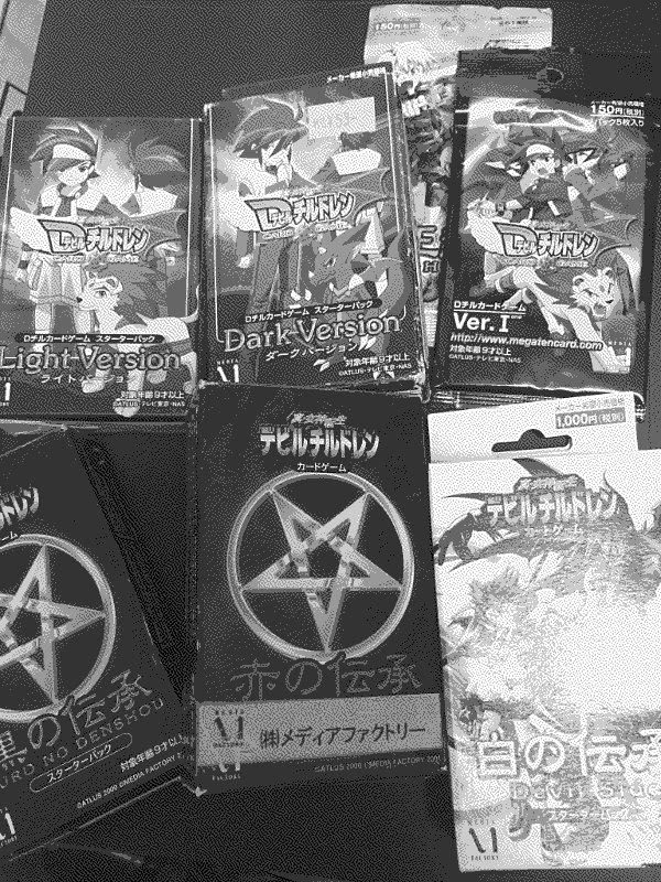 An assortment of packs of cards from the Devil Children Trading Card Game.