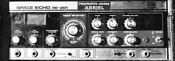 A Roland Space Echo tape delay effect machine, with a sticker applied on the top of the front panel reading; THE CREATIVE ANSWER ABRIEL
