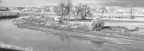 A small shanty town behind a Montana river. A small shanty town behind a Montana river.