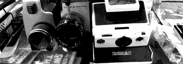 Three vintage cameras on a shelf of antiques, a Yashica 8 U-matic and a Polaroid SX-70 next to an unidentified assumed 8mm camera